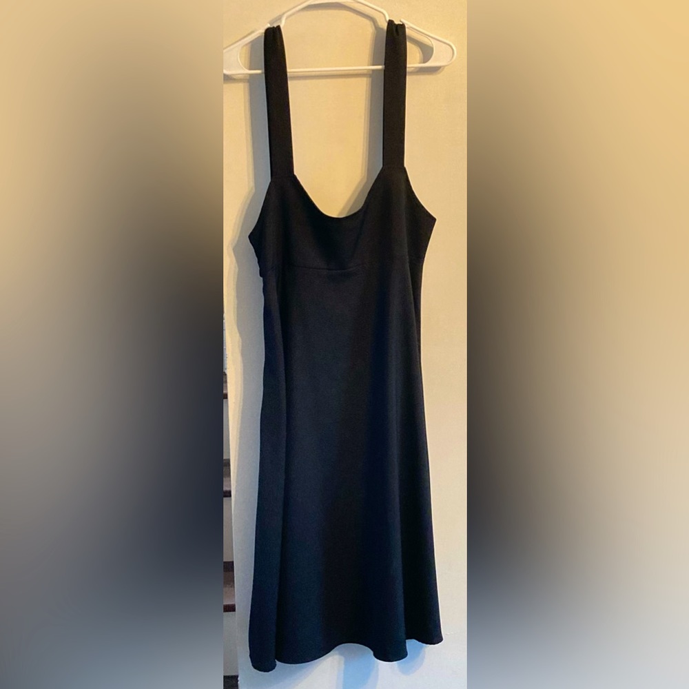 black dress featuring adjustable straps, square neck, and empire waist